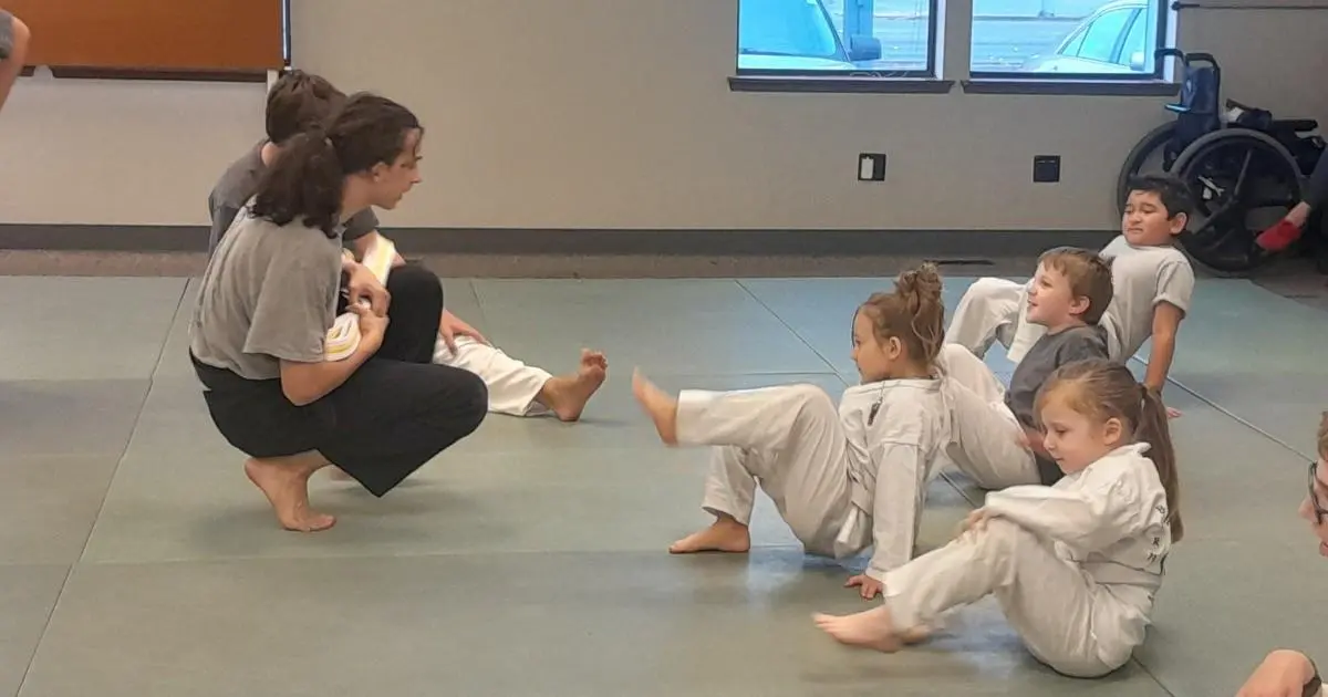 students practicing jiu jitsu moves