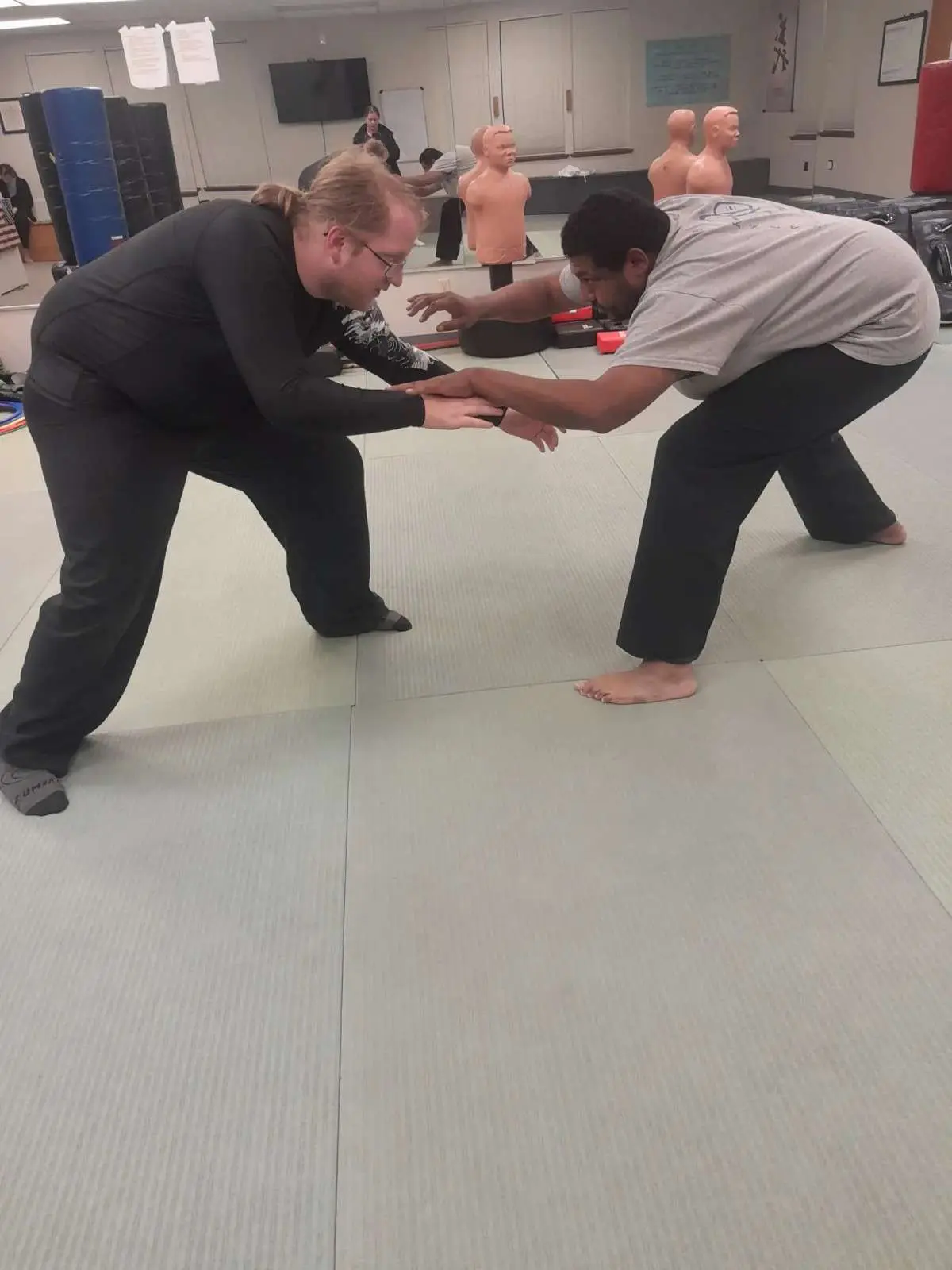 student and teacher sparring during a jiu jitsu class